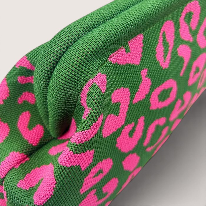 Feather & Sole green knit clutch with hot pink leopard print. Textured fabric, pouch shape.