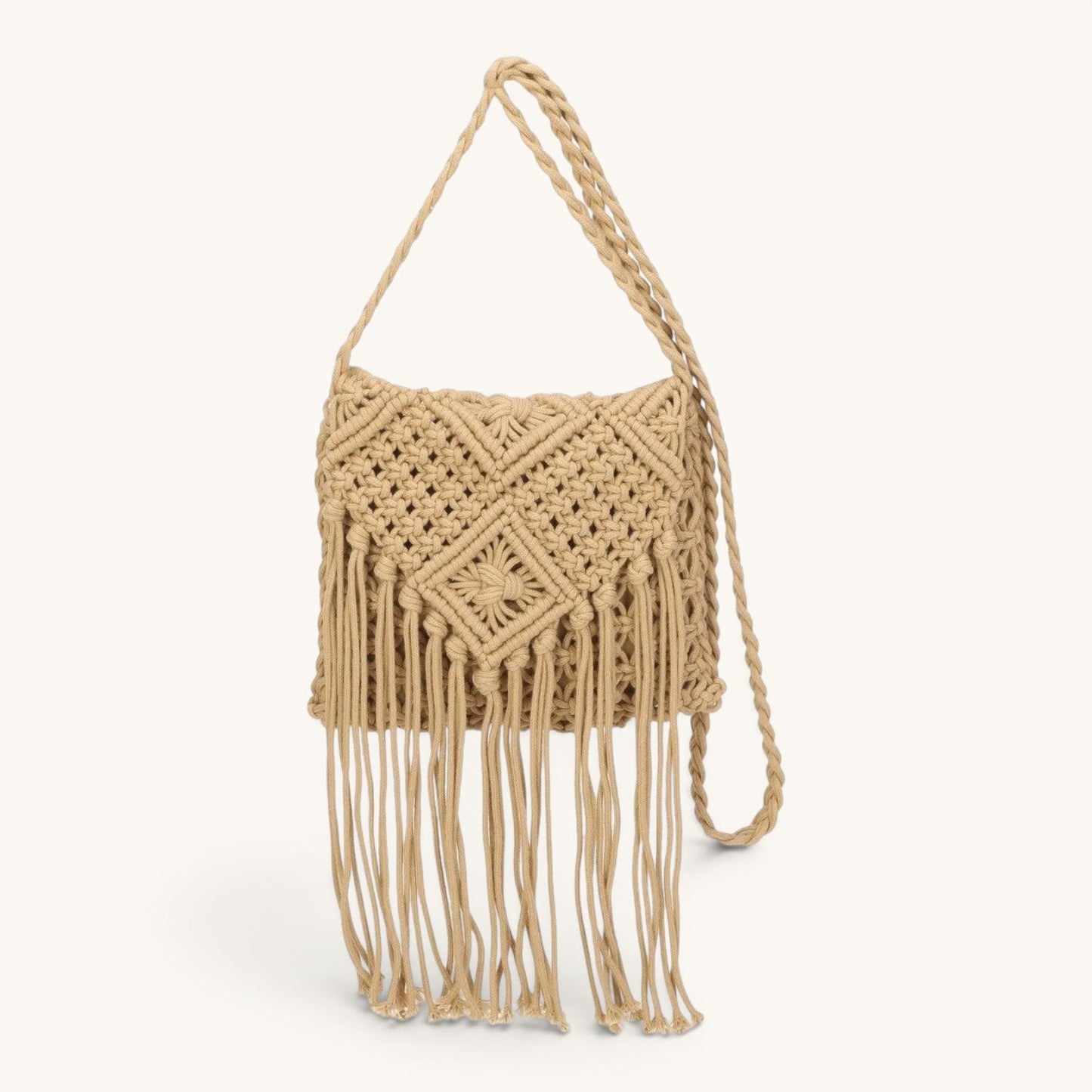 Feather & Sole macrame fringe crossbody bag in natural beige, with top zip closure and long strap.