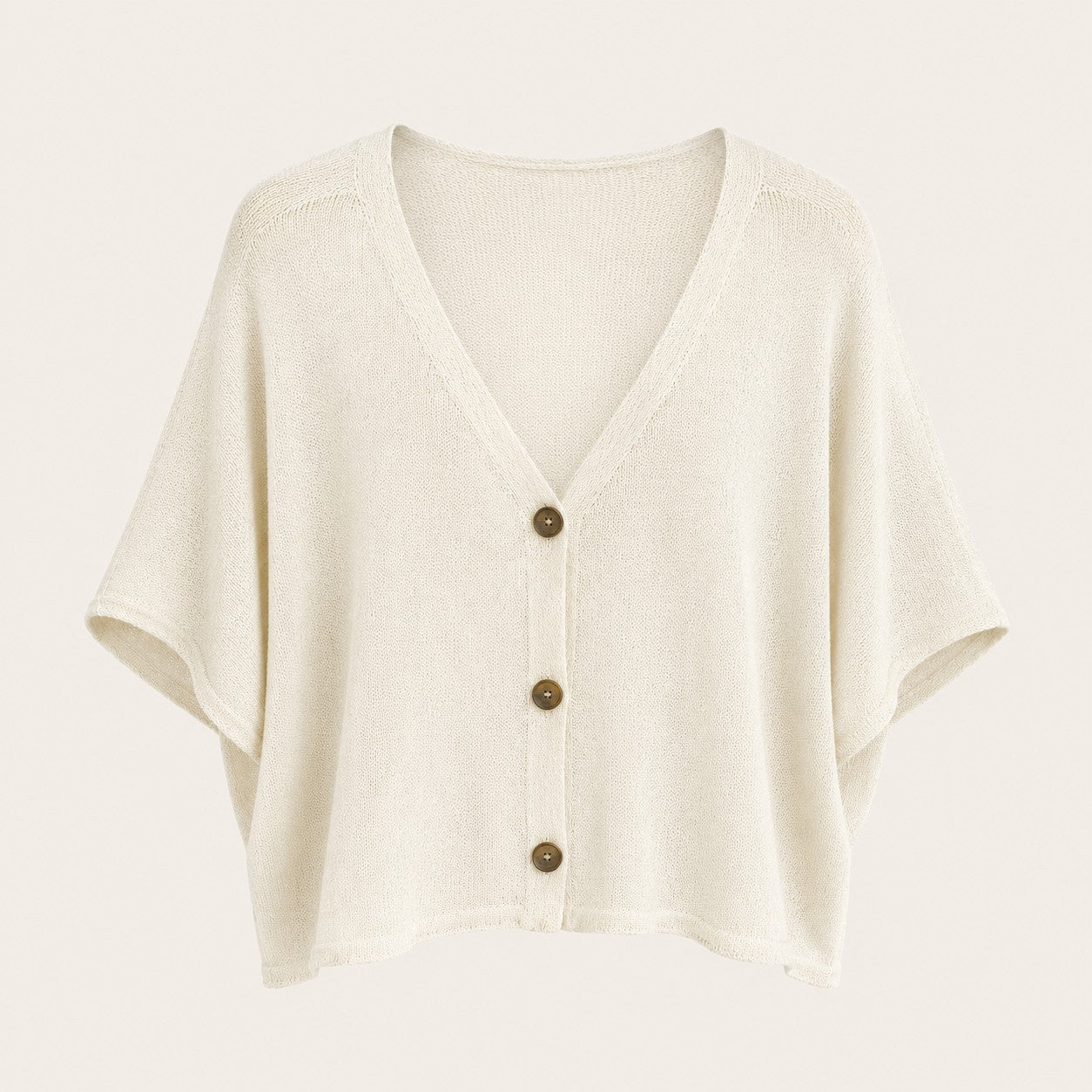 Feather & Sole cream knit cardigan with a V-neck, short wide sleeves, and contrasting dark buttons.