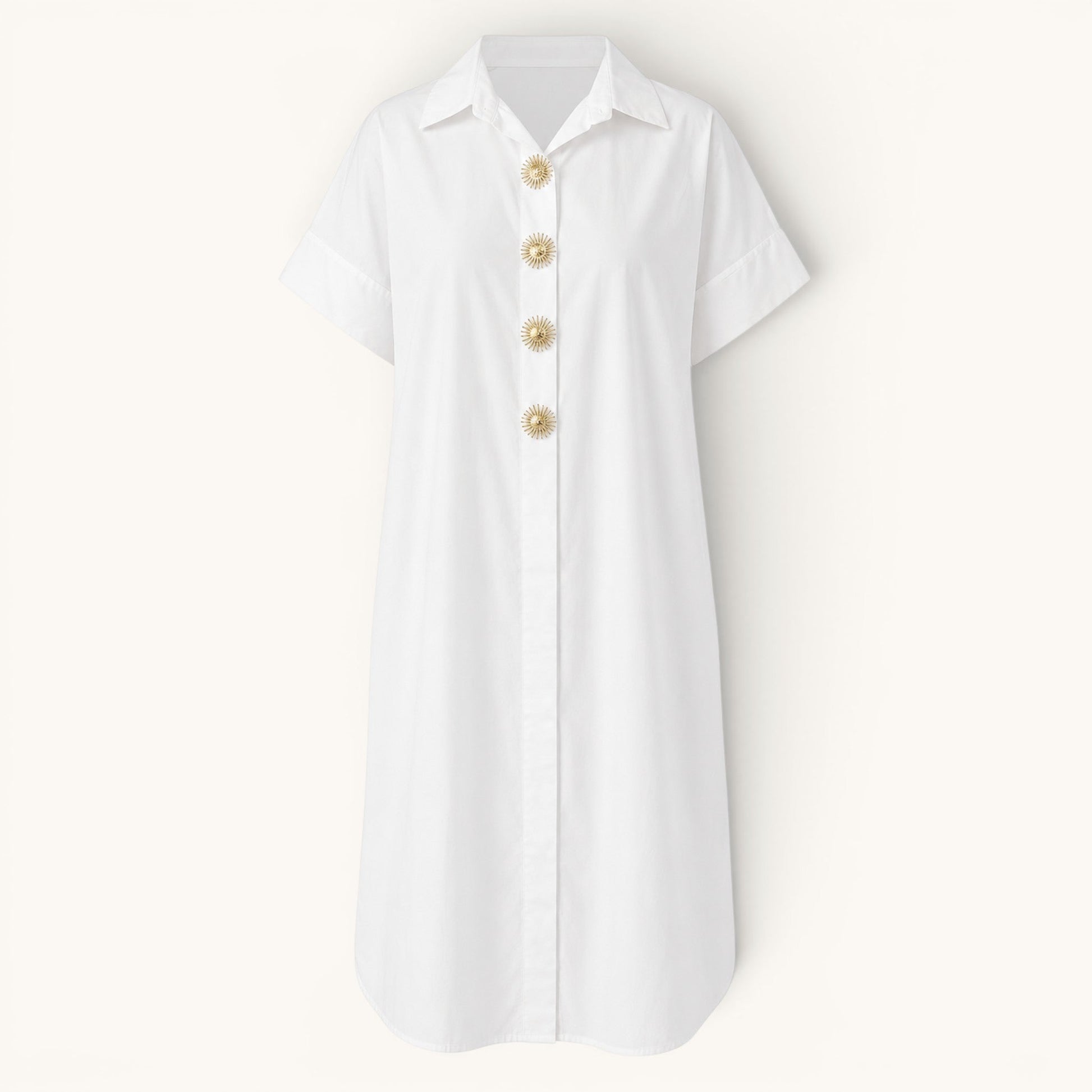 Feather & Sole white oversized cotton shirt dress with short sleeves and decorative gold sunburst buttons.