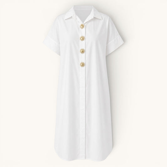 Feather & Sole white oversized cotton shirt dress with short sleeves and decorative gold sunburst buttons.