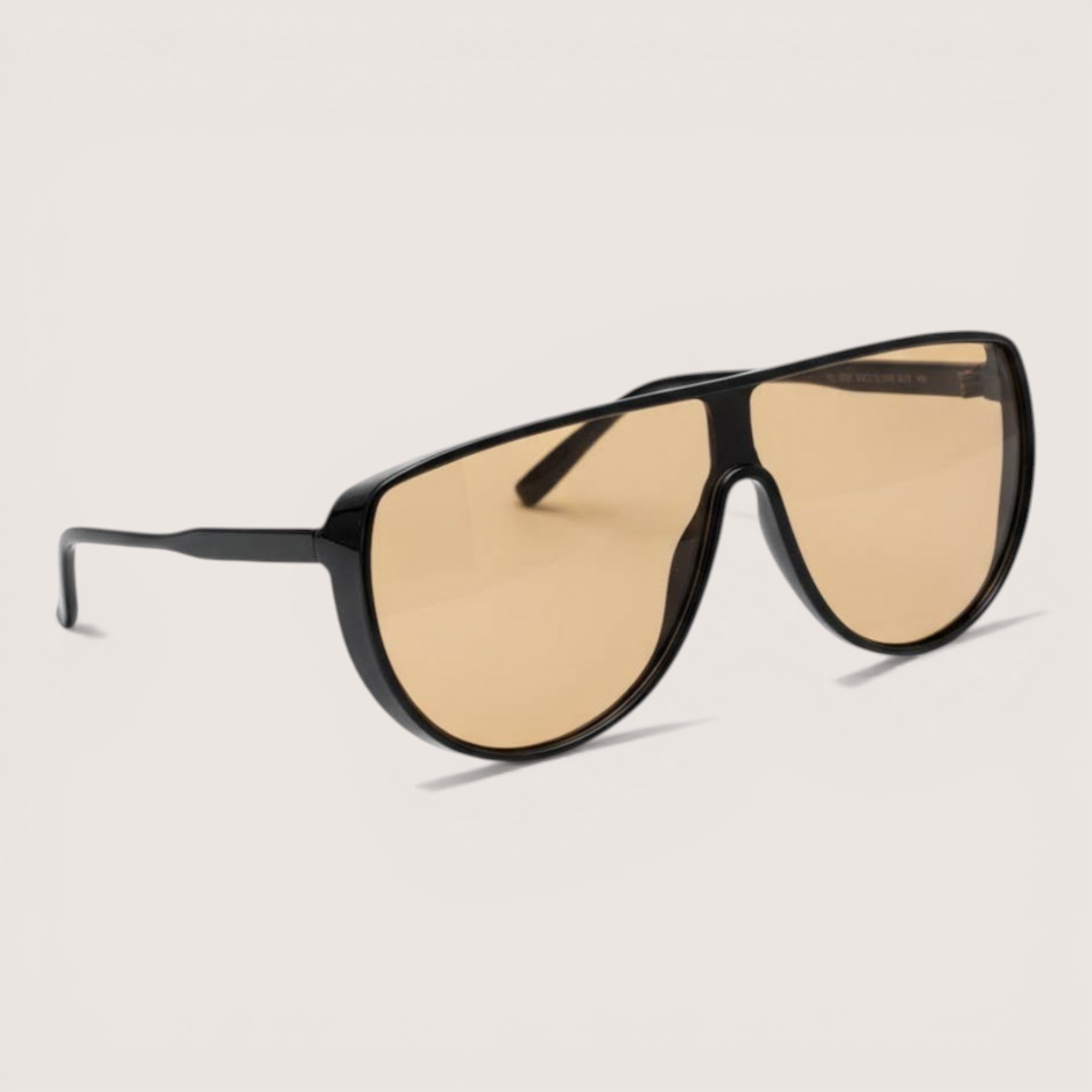 Feather & Sole oversized black aviator sunglasses with light orange lenses and a sleek frame.