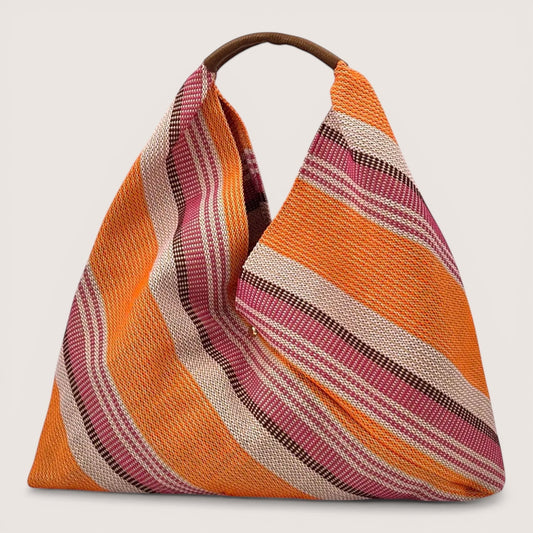 Feather & Sole orange, pink, and cream striped woven shoulder bag with a single brown handle.