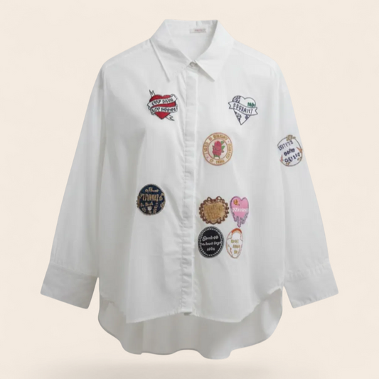 Feather & Sole white cotton oversized shirt with embroidered patches. Relaxed fit, long sleeves, collared.