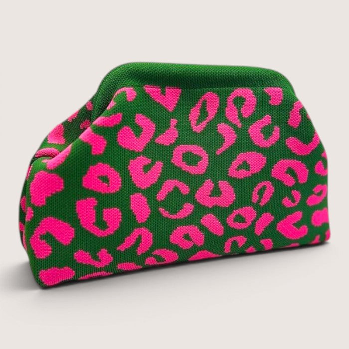 Feather & Sole green knit clutch with hot pink leopard print. Textured pouch-style handbag with structured frame.