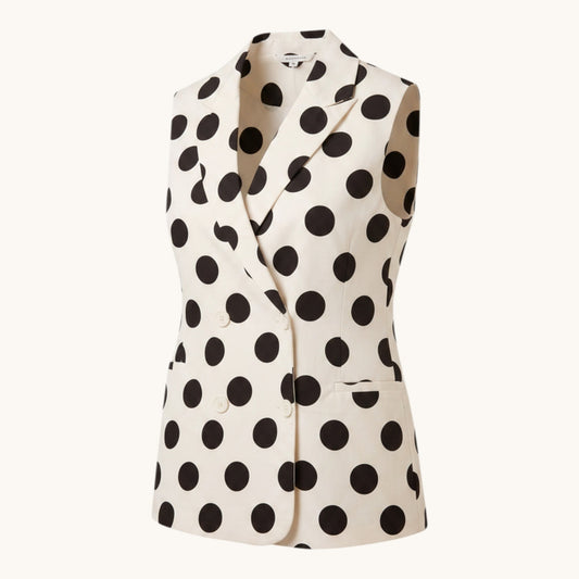 Feather & Sole sleeveless white polyester vest with large black polka dots, notched collar, and double-breasted buttons.